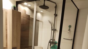A modern bathroom with a glass-enclosed shower, a wooden vanity, and a white sink. - APARTMENT DUPLEX SUPER SAUZE 1700 (LE SUPER SAUZE, Enchastrayes)