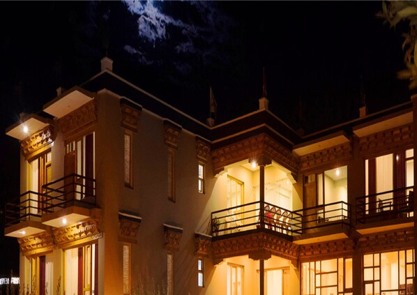 A multi-story building with balconies and large windows, likely a hotel or residential complex.