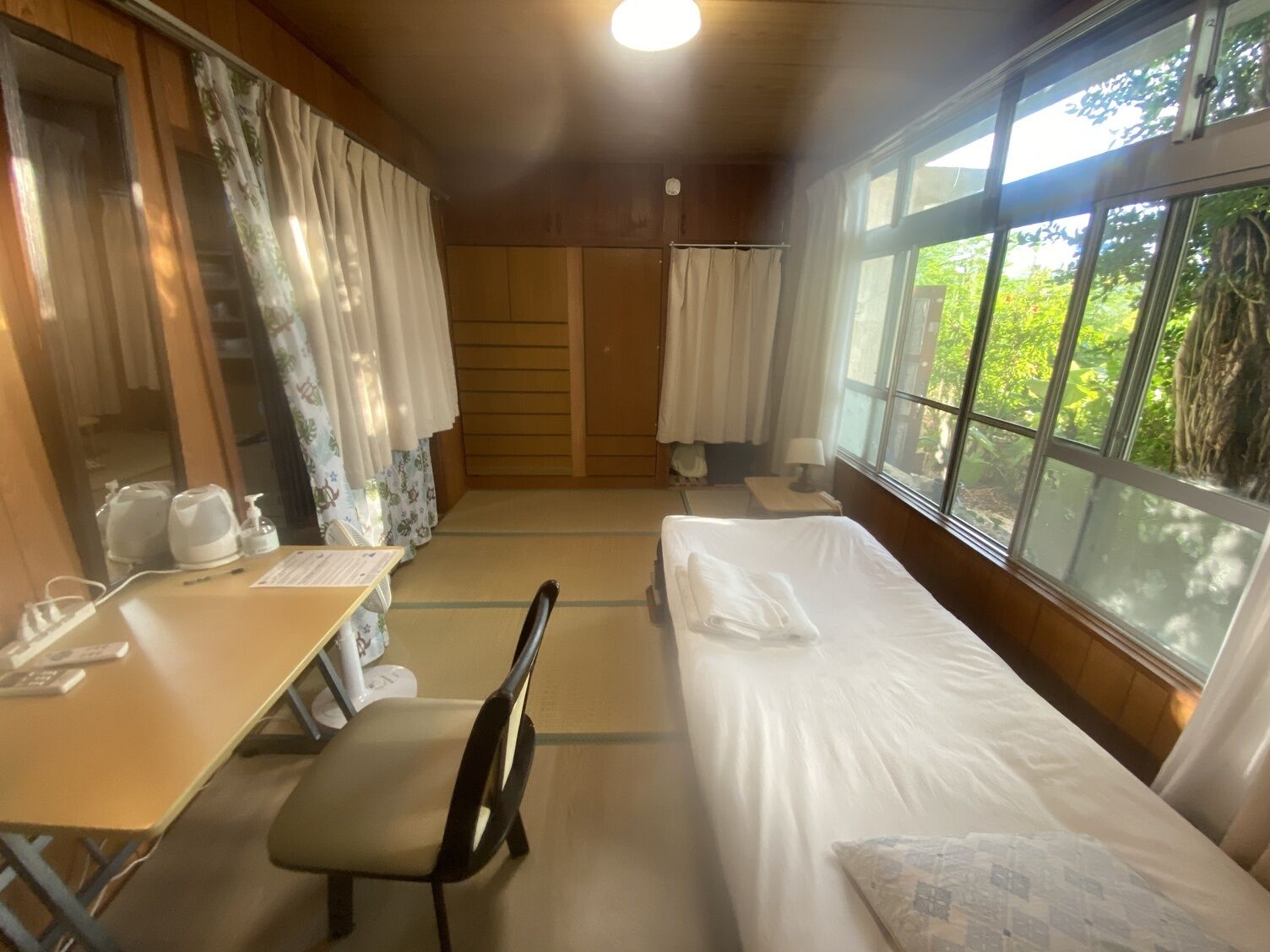 Desk, laptop workspace, blackout drapes, iron/ironing board