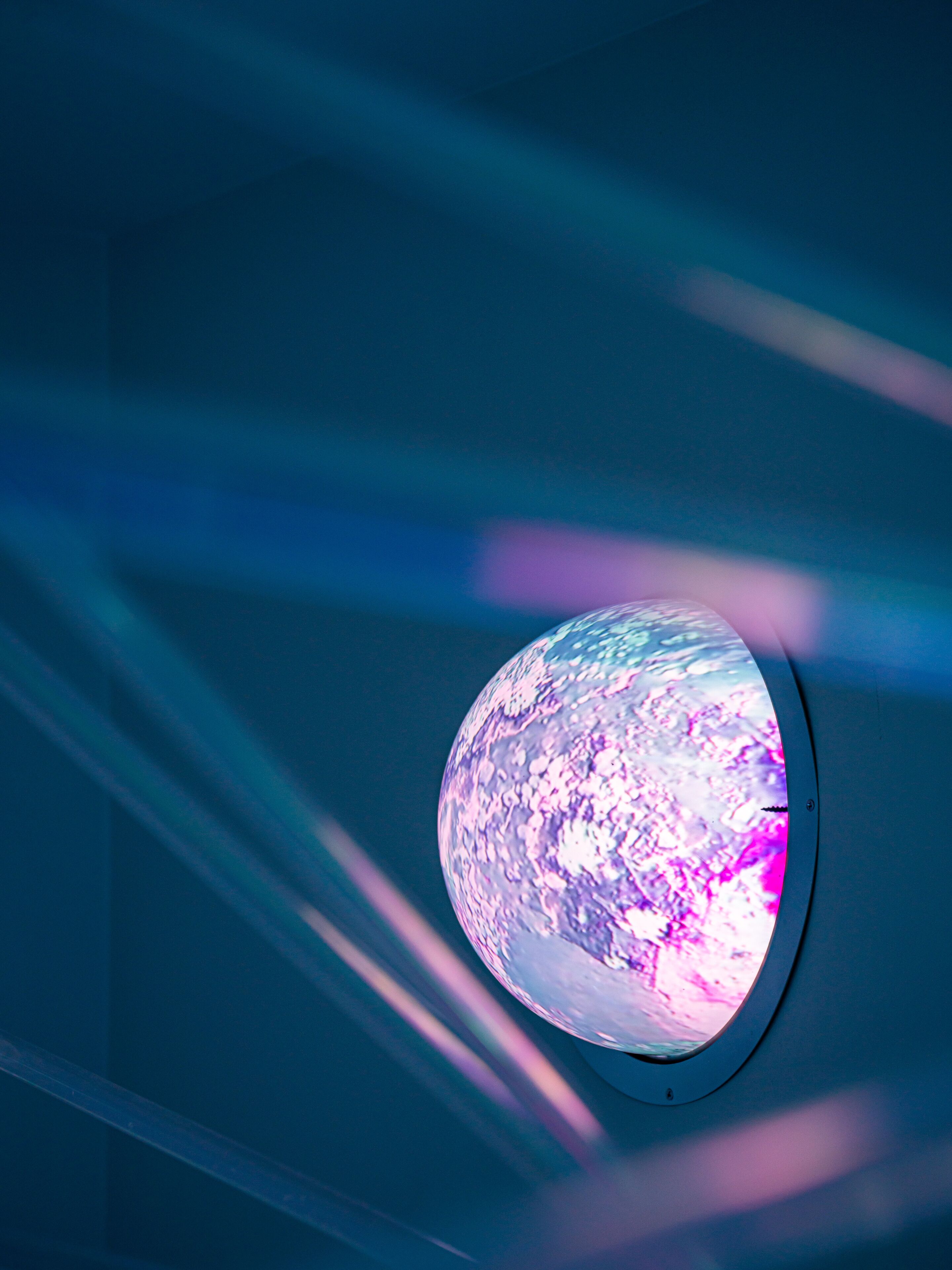 A spherical object with a textured surface, mounted on a wall.