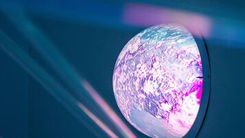 A spherical object with a textured surface, mounted on a wall.