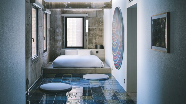 A modern bedroom with a large bed, a window, and a unique tiled floor. - BnA_WALL (Tokyo)
