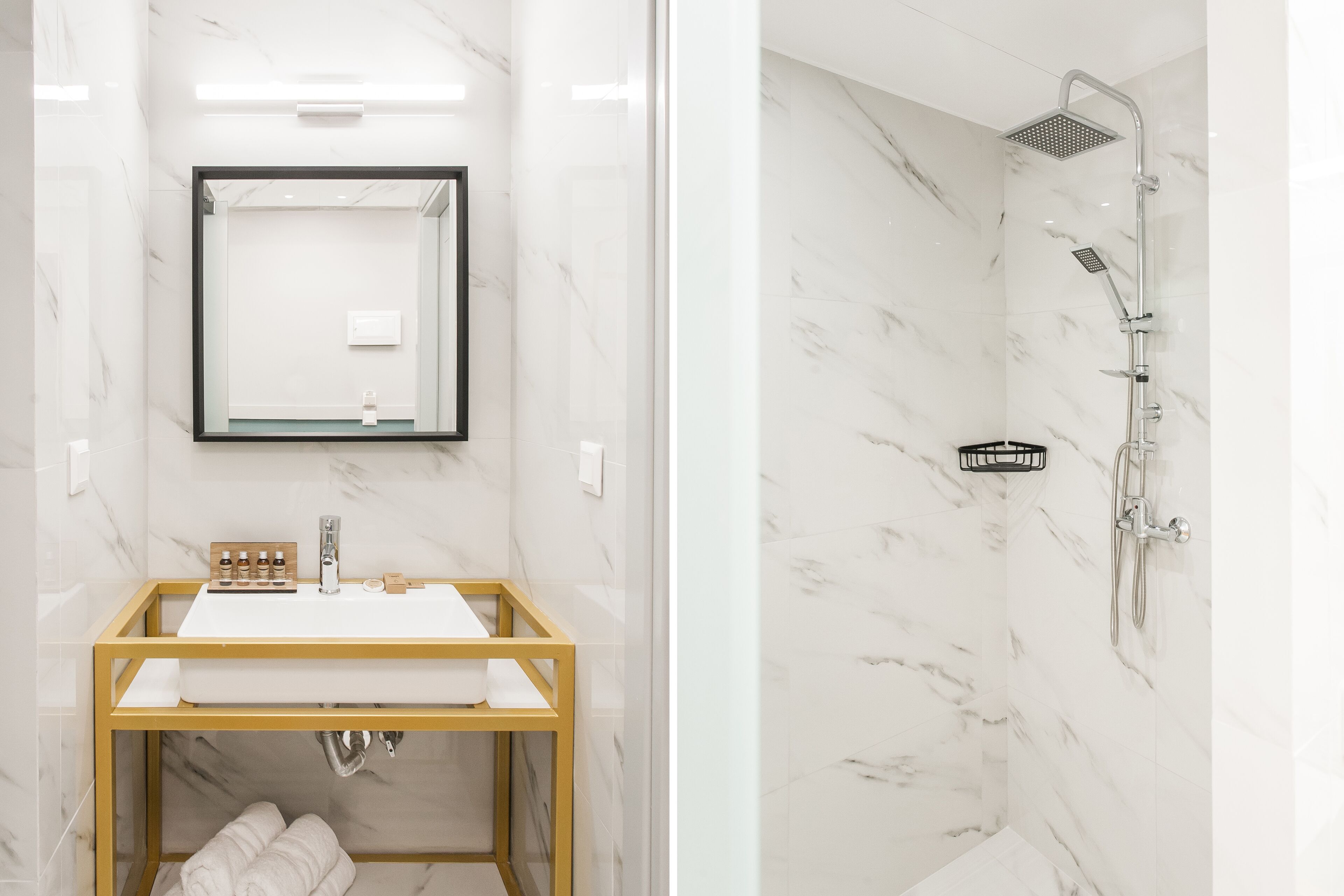 A bathroom with a marble sink, a mirror, and a shower.