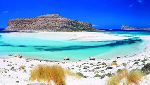 A beach with clear turquoise waters, white sand, and rocky outcrops. - Cretan Dream Villa (Apokoronas)