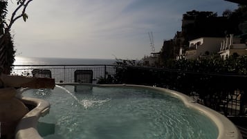 Relax in the hot tub on your balcony with a serene ocean view.