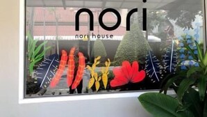 A framed sign with the text "nori house" and decorative elements including stylized leaves and flowers. - Nori House Kata Beach (Karon)