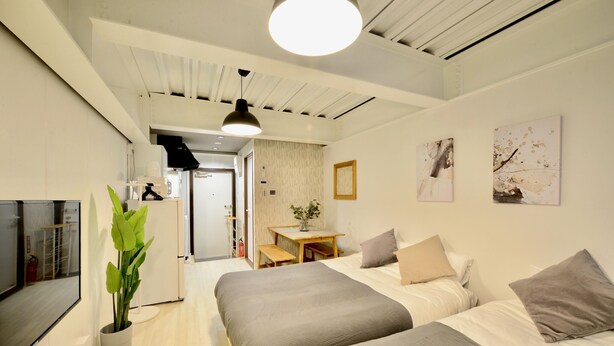 A modern hotel room with two beds, a desk, and a dining area. - Allstay Kotobuki (Naha)