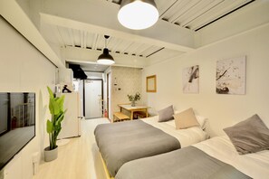 A modern hotel room with two beds, a desk, and a dining area. - Allstay Kotobuki (Naha)