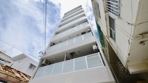 A multi-story building with balconies and large windows. - Allstay Kotobuki (Naha)