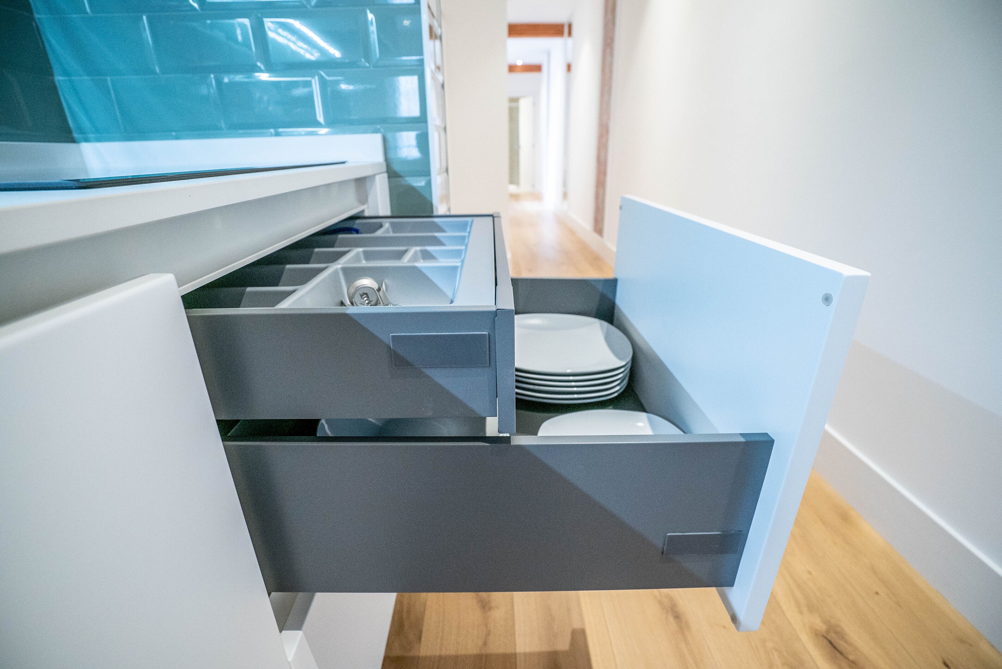 A kitchen with modern appliances, a built-in oven, and a countertop with a sink.