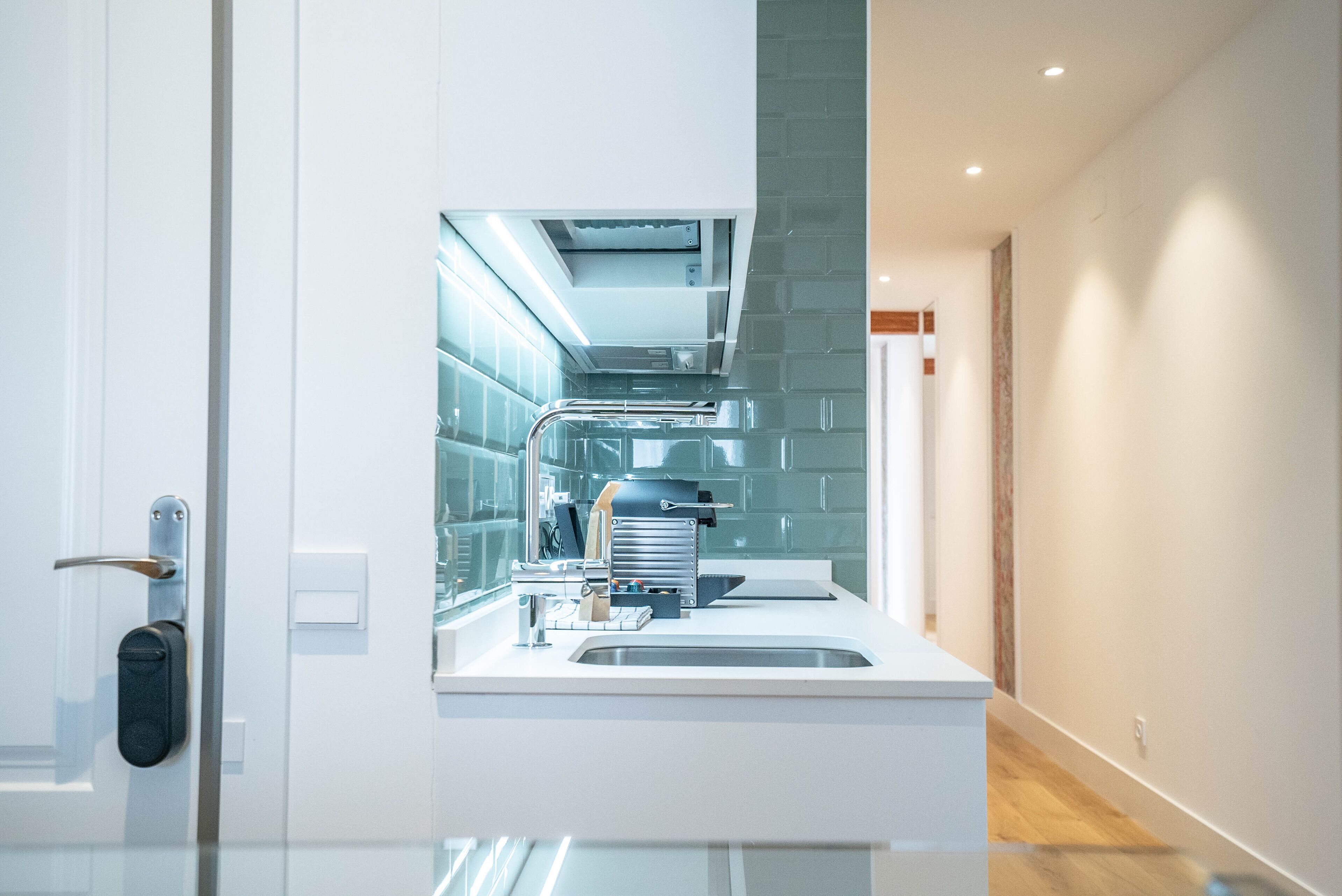 A modern kitchen with a built-in oven, a sink, and a countertop.