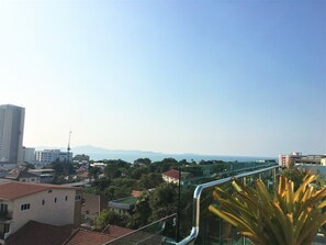 A cityscape with a clear view of the sea and distant mountains. - Fantastic Roof top Pool! (Pattaya)