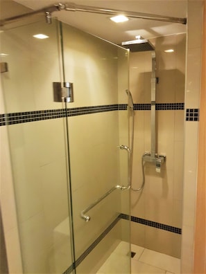 A glass-enclosed shower stall with a handheld showerhead and a wall-mounted faucet. - Fantastic Roof top Pool! (Pattaya)