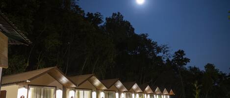 A row of hotel rooms with a moon in the sky.