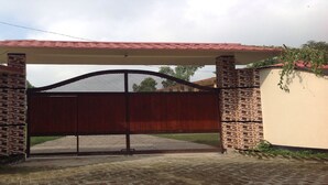 A gated entrance with a tiled roof and brickwork.