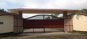 A gated entrance with a tiled roof and brickwork.