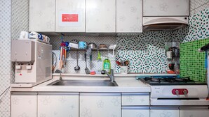 A kitchen with a coffee maker, sink, stove, and various utensils. - Dream Single House (Seoul)