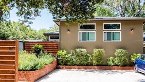 A single-story house with a beige exterior, a front porch, and a garage.