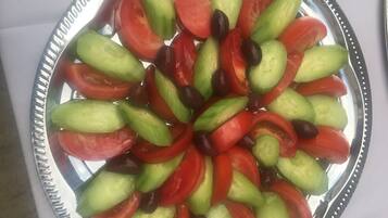 A plate of sliced vegetables arranged in a circular pattern.