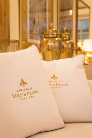 Two pillows with 'Penthouse Mey's Place' text, placed on a bed.