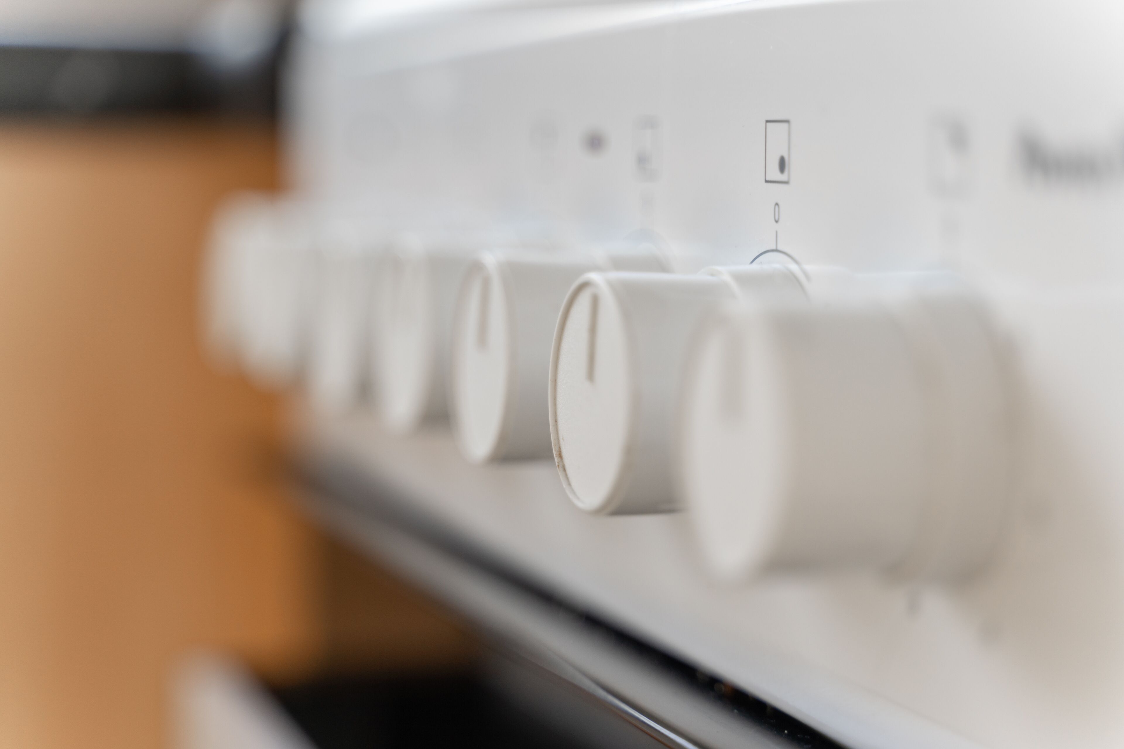 A close-up of a control panel with several knobs and a switch.