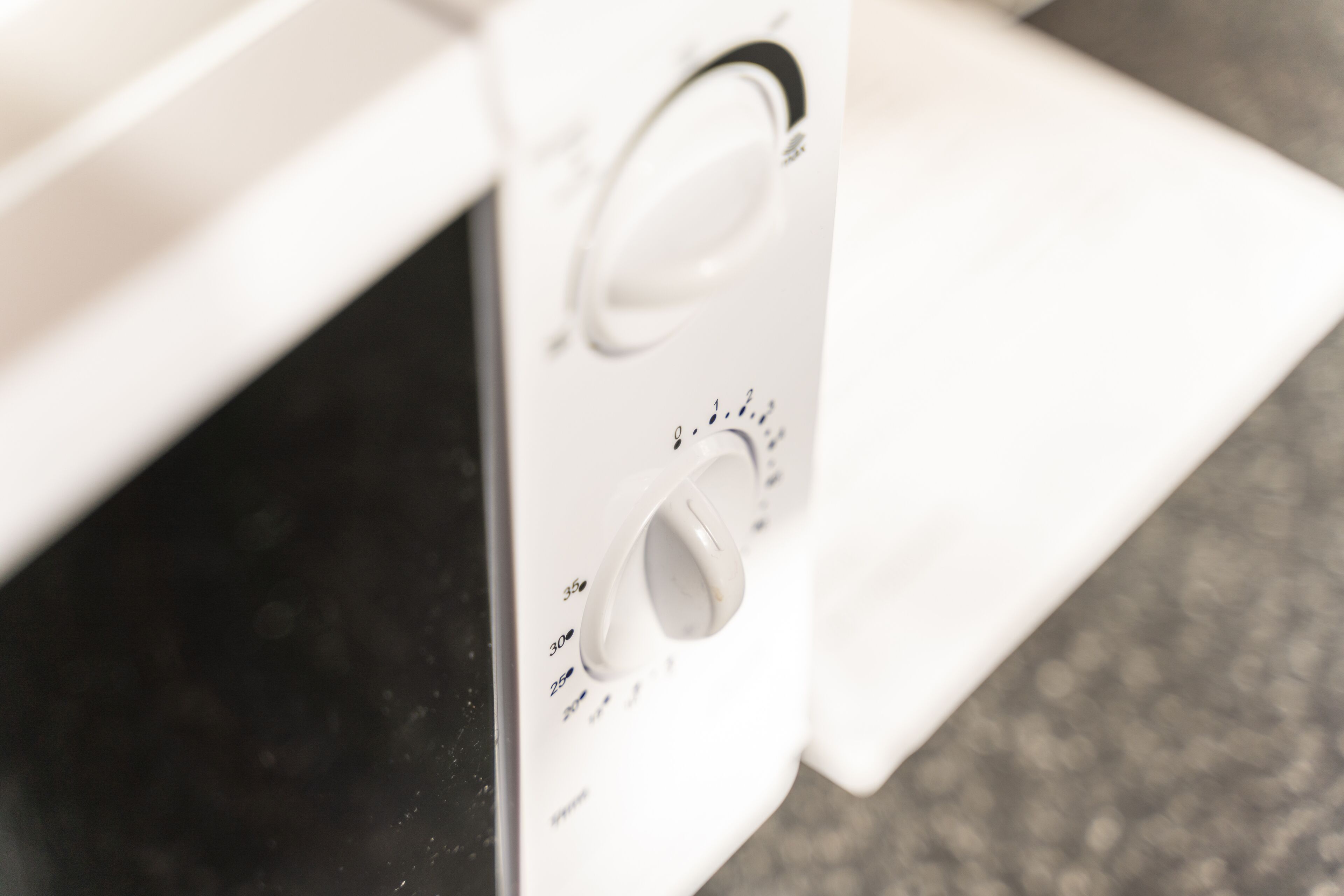 A close-up of a microwave control panel with temperature settings.
