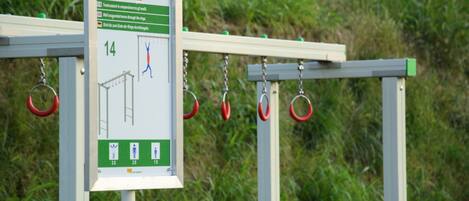 A metal structure with a signboard and rings for climbing.