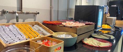 A buffet setup with various food items and condiments.