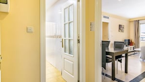 A hotel room with a large window, a desk with a chair, and a small table. - Magnifico apartamento en Marbella (Marbella)