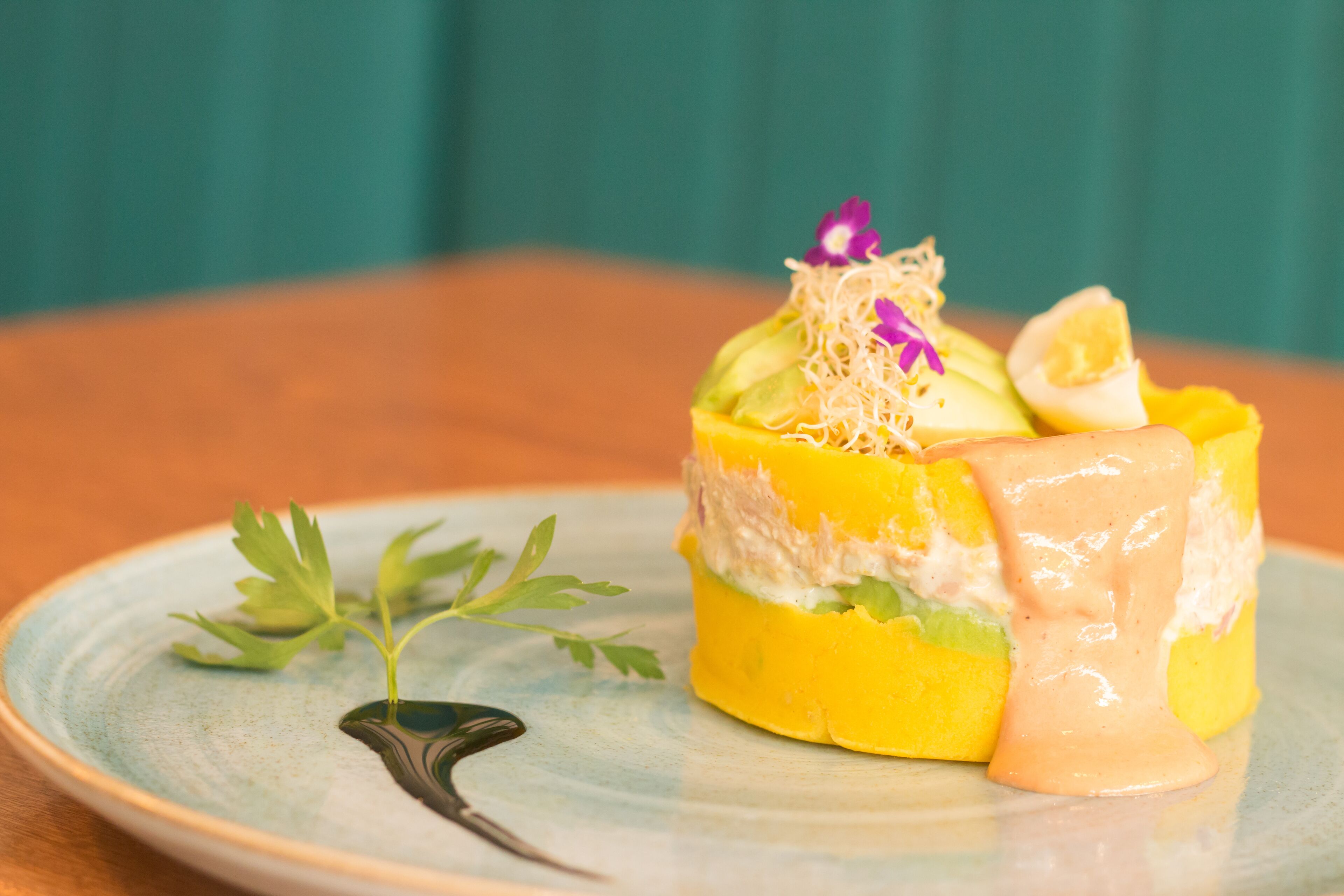 A dessert on a plate with a green background.