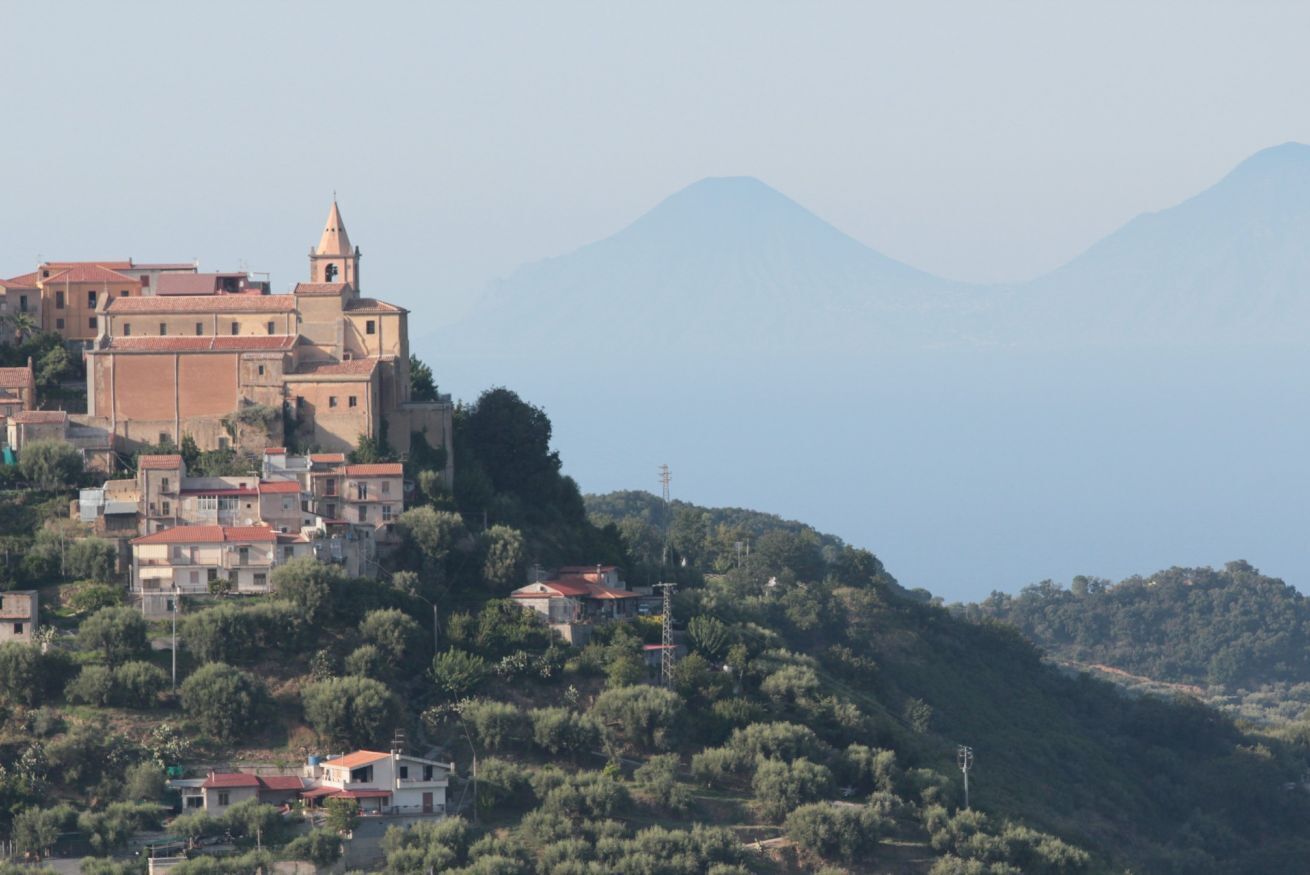 A hillside town with a prominent church and residential buildings.