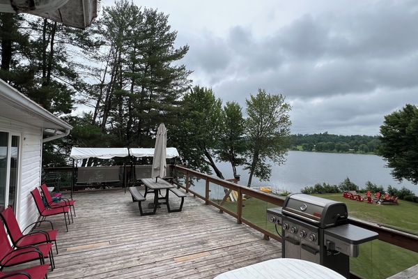 Raised deck facing backyard/lake, large bbq, 2 swings, 2 tables and lots chairs
