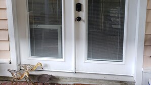 A white door with two glass panels and a black intercom.