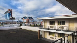 A motel with a balcony, a parking lot, and a sign indicating the name "Viking Motel". - Viking Motel (Detroit)