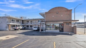 A building with a brick facade and a covered entrance area. - Viking Motel (Detroit)