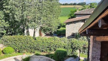 Surrounded by lush gardens and a tranquil field, this serene setting offers a peaceful escape.
