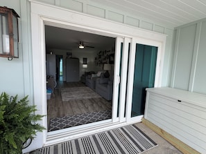 A room with a sliding glass door leading to a living area, a ceiling fan, and a patterned rug. - Can you say PRIVATE? The best kept secret on 30A! (Panama City Beach)