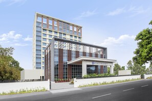 A modern hotel building with a glass facade, a prominent entrance, and a sign reading "HYATT RESIDENCY". - Hyatt Regency Thrissur (Thrissur)