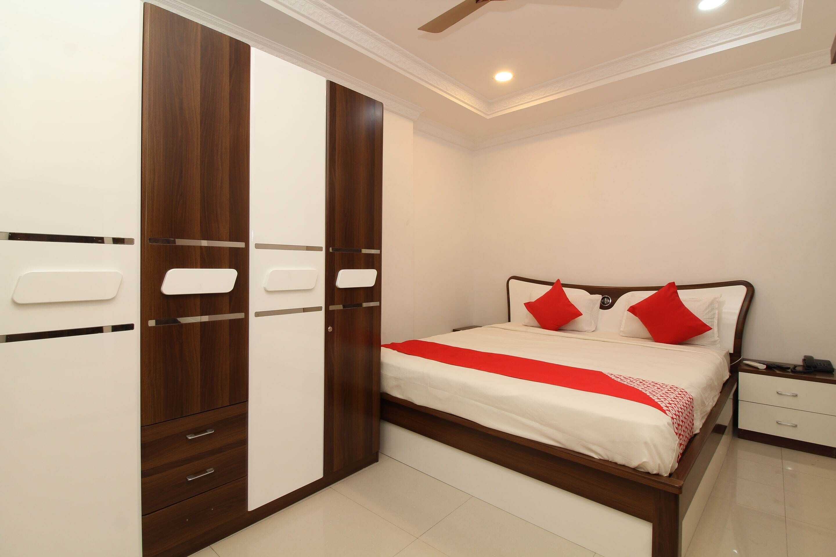 A bedroom with a bed, a wardrobe, and a nightstand.
