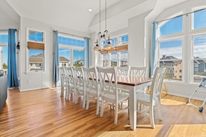 Enjoy meals in this dining area with a central table and comfortable seating for all.