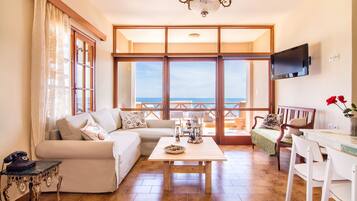 Apartment, 2 Bedrooms, Sea View (Sirokos) | Living room | Flat-screen TV