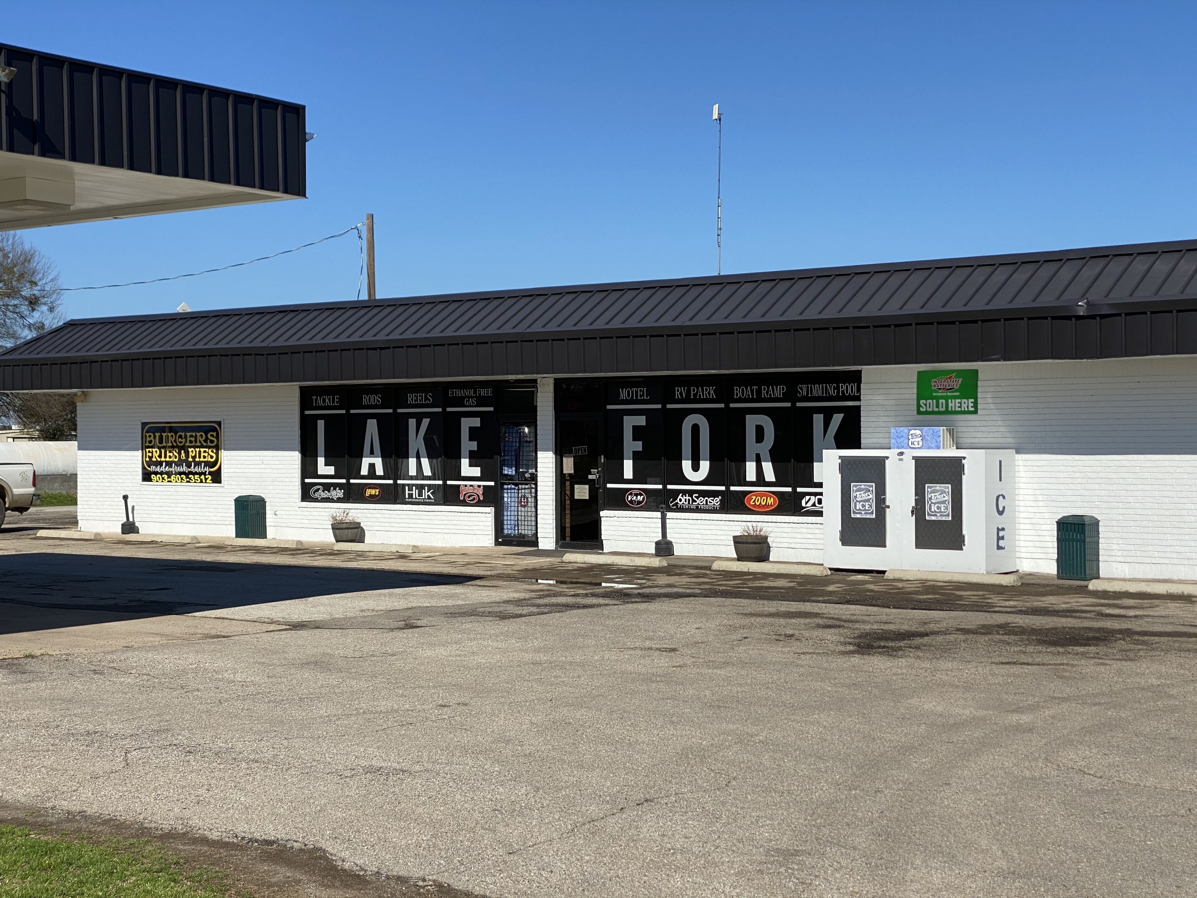 A building with a sign that reads "LAKE FORK" and "Burgers, Fries & Pies."