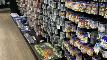 A store aisle with shelves stocked with various fishing tackle and accessories.
