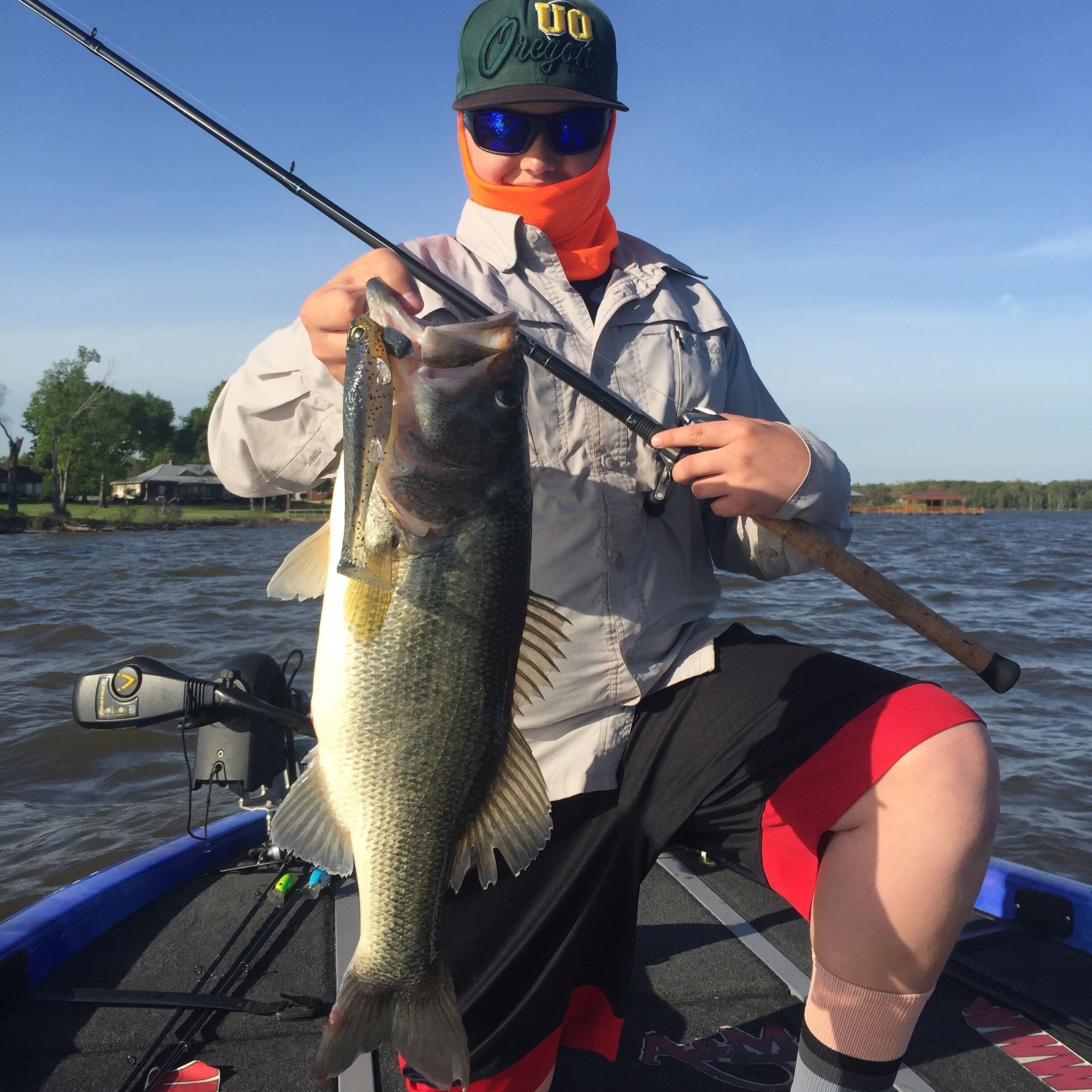 A person holding a fish on a boat.