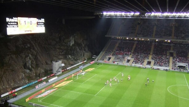 A stadium with a football field, seating, and a scoreboard. - Hotel São Nicolau (Braga)