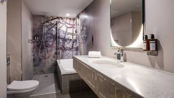 A modern bathroom with a shower, toilet, and vanity.