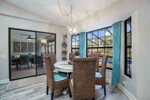 Enjoy meals in this cozy dining area with a round table and comfortable wicker chairs.