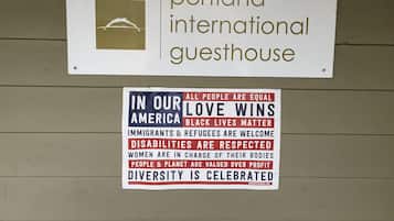 A sign for Portland International Guesthouse with a list of values including equality, love, and respect for all people.