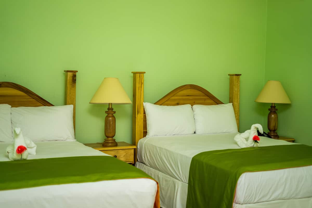 Deluxe Quadruple Room, 2 Queen Beds, Garden View | In-room safe, desk, blackout drapes, soundproofing