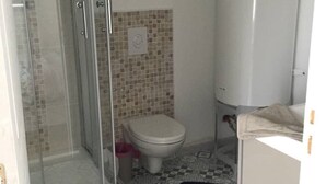 A bathroom with a shower, toilet, and a white cabinet. - SWEET HOME GOLF OF APREMONT (Apremont)